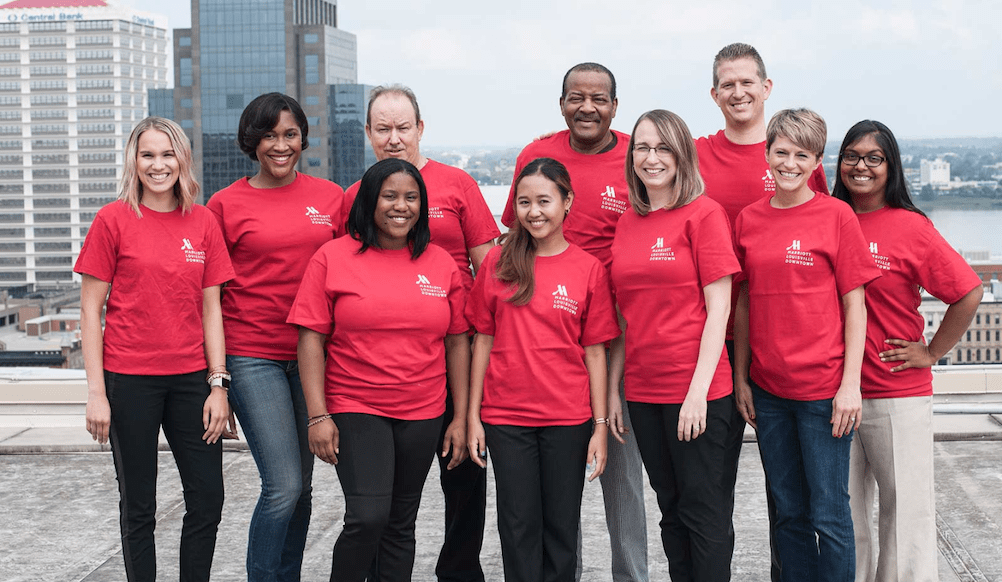 A group of hotel associates wearing red tshirts